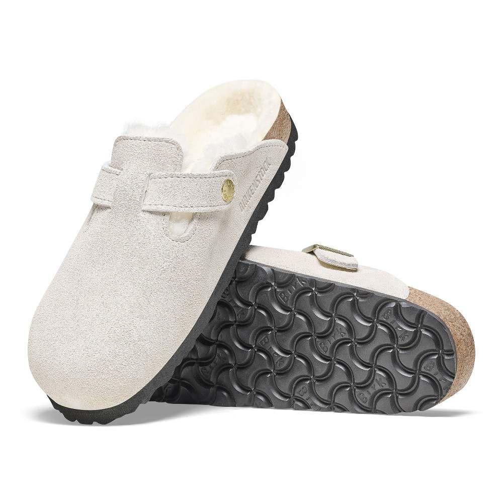 A pair of Birkenstock Boston VL Shearling sandals in antique white.