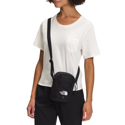 The North Face Jester Crossbody in black, featuring a compact design with multiple compartments and an adjustable strap.