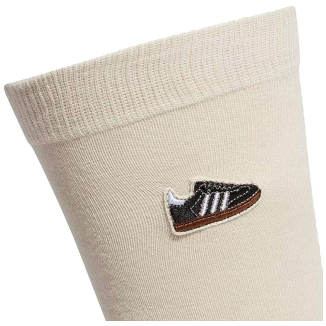 A close-up view of adidas Originals Samba Socks in clear brown