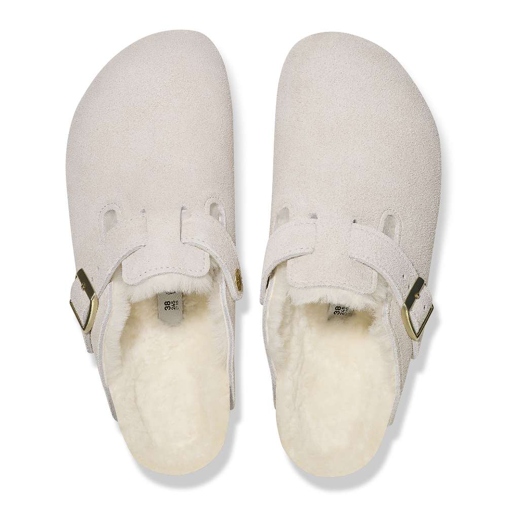 A pair of Birkenstock Boston VL Shearling sandals in antique white.