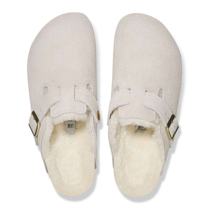 A pair of Birkenstock Boston VL Shearling sandals in antique white.