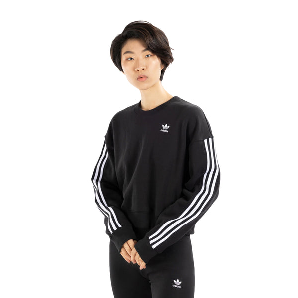 Stay cozy and chic in the adidas Women's Sweatshirt, a versatile wardrobe essential in a stylish design.
