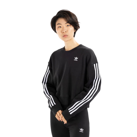 Stay cozy and chic in the adidas Women's Sweatshirt, a versatile wardrobe essential in a stylish design.