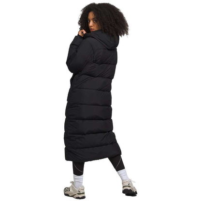 A sleek black north face women's triple c parka worn by women.