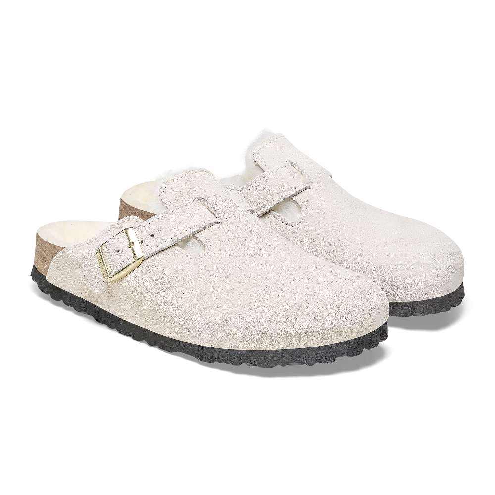 A pair of Birkenstock Boston VL Shearling sandals in antique white.