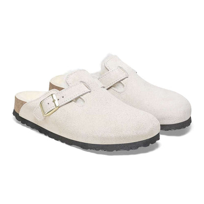 A pair of Birkenstock Boston VL Shearling sandals in antique white.
