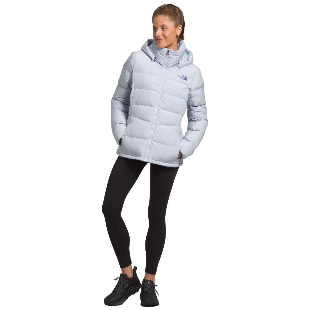 A stylish North Face Women's Metropolis Jacket in dusty periwinkle worn by a woman against a snowy backdrop.