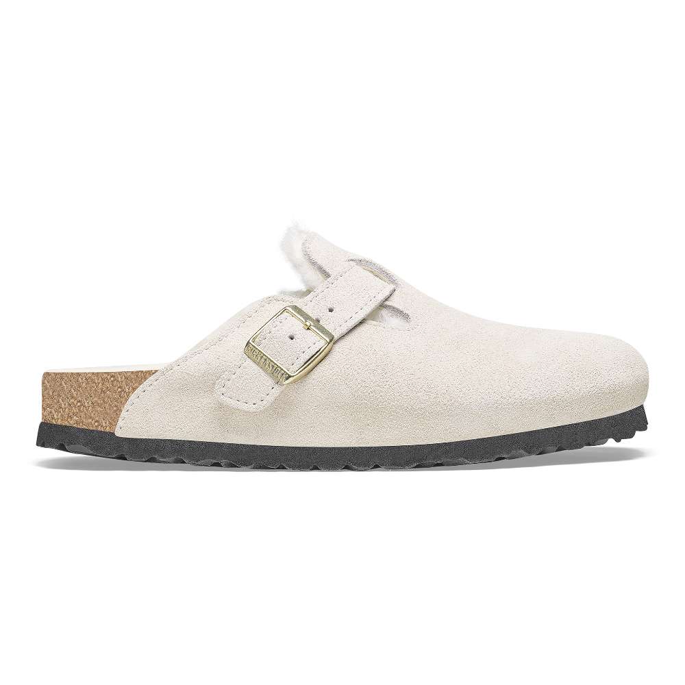 A pair of Birkenstock Boston VL Shearling sandals in antique white.