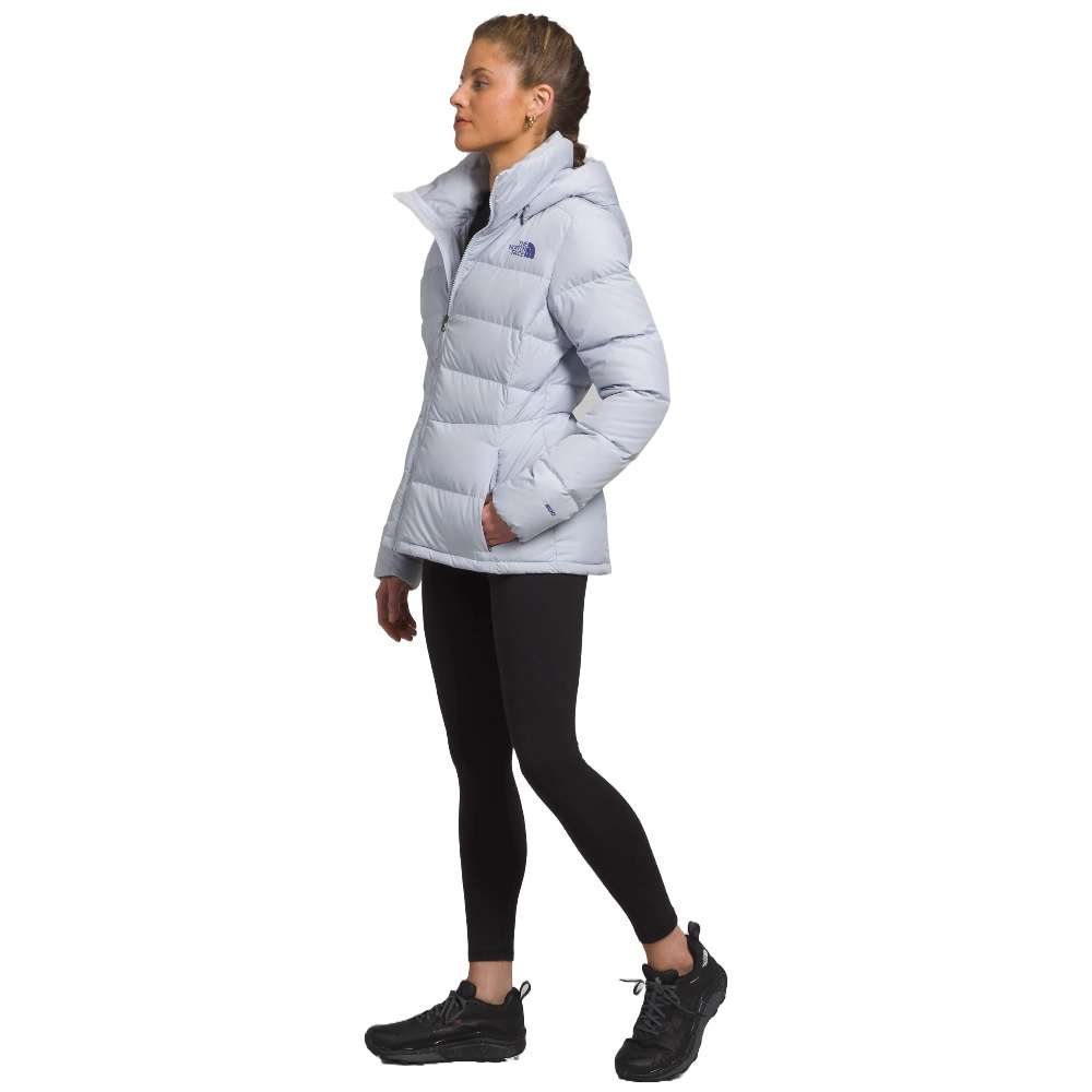 A stylish North Face Women's Metropolis Jacket in dusty periwinkle worn by a woman against a snowy backdrop.