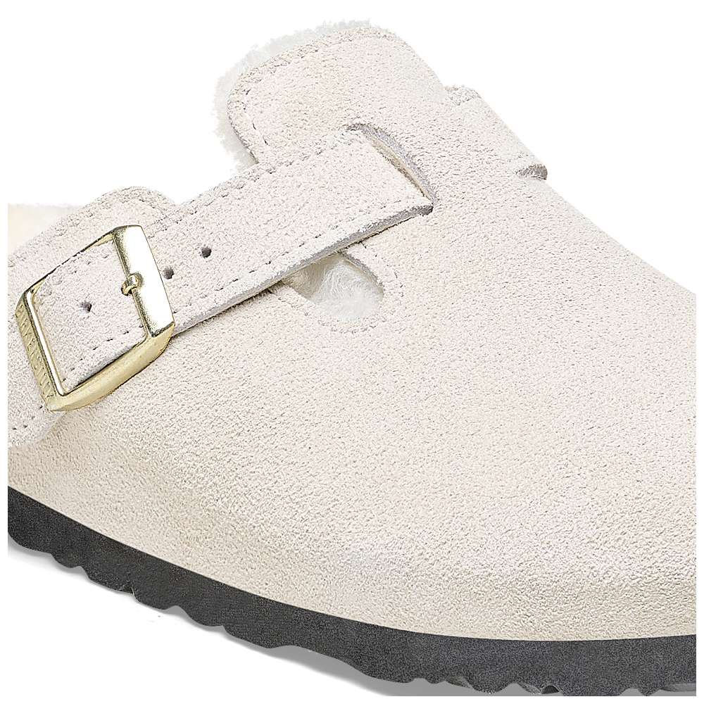 A pair of Birkenstock Boston VL Shearling sandals in antique white.