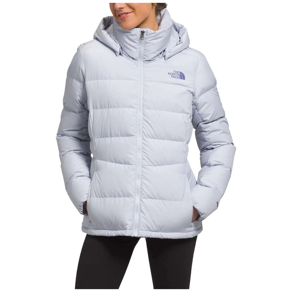 A stylish North Face Women's Metropolis Jacket in dusty periwinkle worn by a woman against a snowy backdrop.