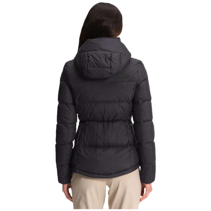 A stylish North Face Women's Metropolis Jacket in sleek black, worn by a woman against a snowy backdrop.
