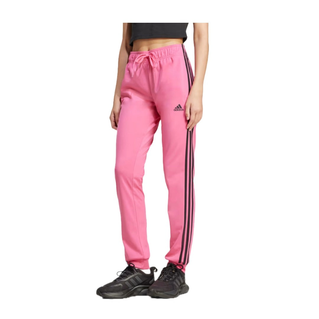 Women’s slim tapered track pants featuring lightweight recycled fabric, an elastic drawstring waistband, side pockets, signature side stripes, and a streamlined athletic fit for training and everyday wear
